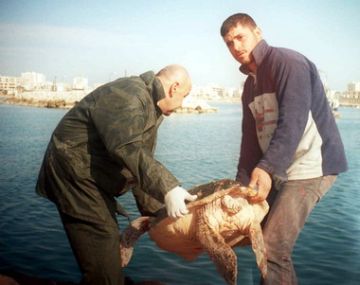 Photo 3. Mohammad Jony (left) returning a tagged loggerhead to the sea.