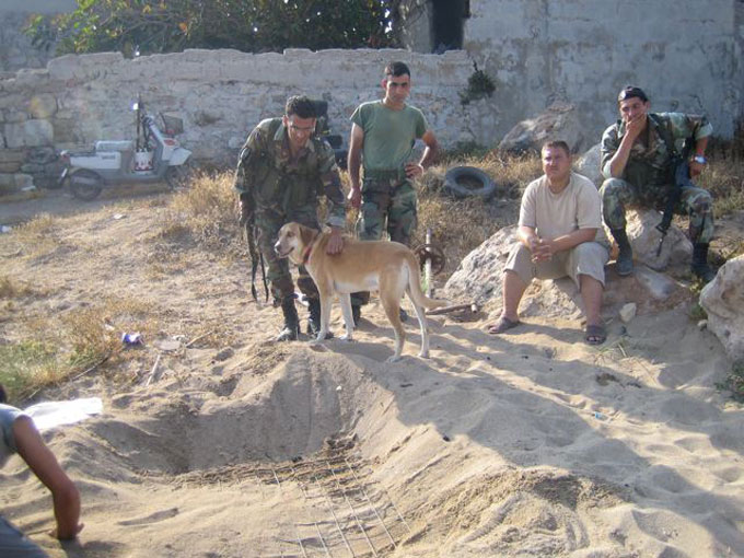 Fig. 2. Soldiers watching the placement of nest protection mesh.